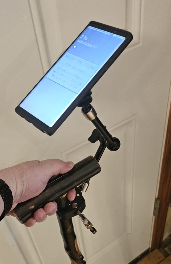 The assembled Type I Technocane. It's a SmallRig Magic Arm clamped to a simple wooden cane. The free end of the SmallRig Arm has a magnet mount on it to hold my phone.